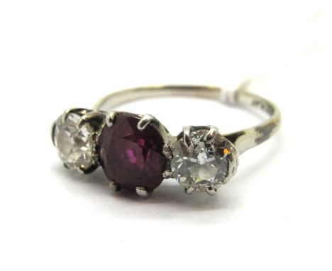 A Ruby and Diamond Three Stone Ring, oval four claw set to the centre between two old cut diamonds, stamped "18ct Plat".