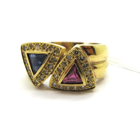 A Modern Sapphire, Diamond and Ruby Set Dress Ring, triangular set between wide shoulders.