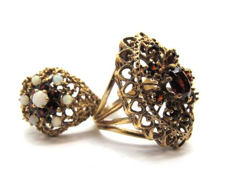 A Large 9ct Gold Garnet Set Dress Ring, of openwork design claw set throughout; A 9ct Gold Opal and Garnet Set Cluster Dress 