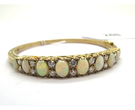 A 9ct Gold Victorian Style Opal and Diamond Set Bangle, alternately graduated set throughout to the front, hinged to snap cla