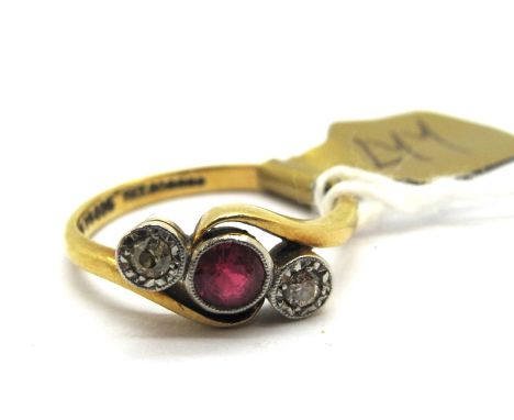 A Ruby and Illusion Set Diamond Three Stone Ring, the old cut stones collet set, between twist shoulders stamped "18ct".