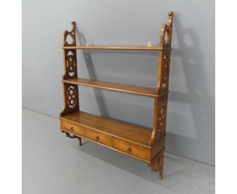 A 19th century style magoany three tier hanging shelf, with pieced decoration and three drawers. Width 78cm, height 102cm, de