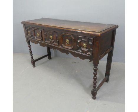 An antique oak Jacobean style sideboard, with three drawers and bobbin turned legs, labled for Oetzmann &amp; Co. Ltd.. Width