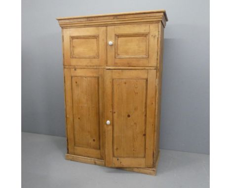 A vintage pine larder cupboard, with four panelled doors and shelf fitted interior. Width 107cm, height 155cm, depth 46cm.