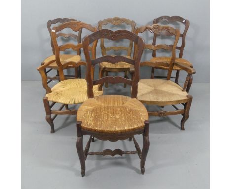 A matched set of French oak rush-seated ladder-back dining chairs. (4+2).