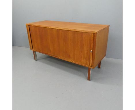 A mid-century teak sideboard with tambour sliding front, and shelf fitted interior, in the manner of Nipu. Width 120cm, heigh