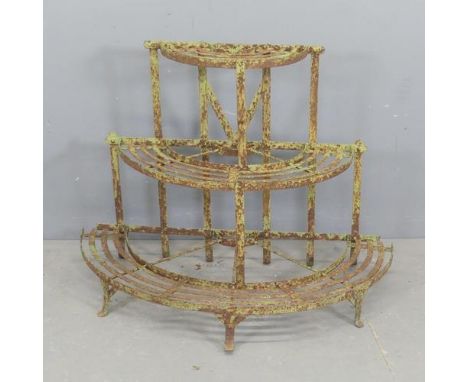 A painted cast iron semi-circular plant stand. Width 100cm, height 73cm, depth 55cm.