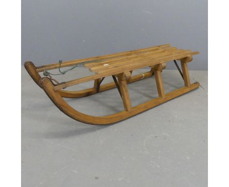 A vintage pine sledge with metal runners. Length 103cm.