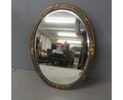 A painted chinoiserie decorated oval bevel-edged wall mirror. Width 59cm, height 46cm.