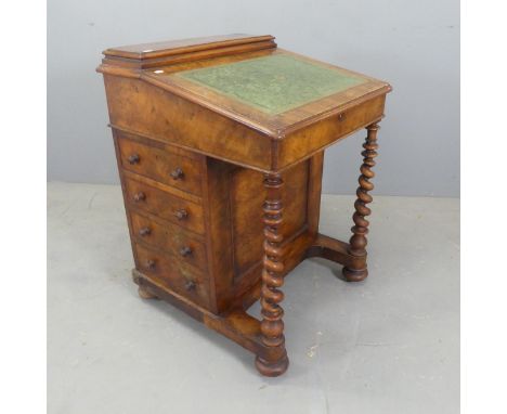 A Victorian walnut davenport. Width 62cm, height 85cm, depth 62cm.