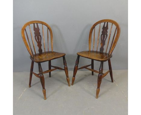 Two similar 19th century elm-seated stick back side / dining chairs.