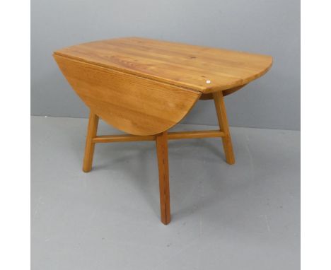 ERCOL - A Mid-century pine drop-leaf table with blue maker's label. Length 113cm, height 72cm, width 61cm (extending to 125cm