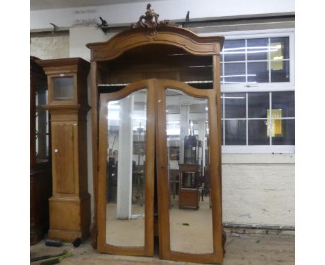 An early 20th century French walnut armoire with two mirrored doors and adjustable shelf-fitted interior. Width 140cm, height