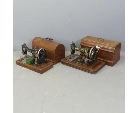 A vintage cased Singer sewing machine, a cased German Frister &amp; Rossmann sewing machine, and a mahogany tripod stand. (3)
