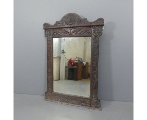 A 19th century oak-framed over-mantel bevel-edged mirror with carved decoration. Width 102cm, height 145cm.