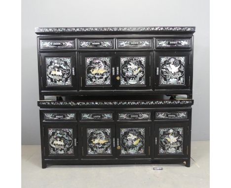 A pair of Korean black lacquered low cabinets, each with four drawers above four cupboard doors, and with hardstone and inlai