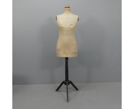 A vintage shop display mannequin, mounted on painted tripod base and labelled for Stockman's. Height 153cm.