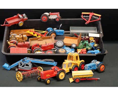 Over 20 play worn mid 20th C diecast farming models to include tractors, trailers and accessories, features Dinky, Matchbox &