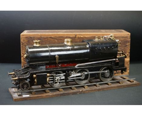 Metal/brass O gauge 2-6-0 steam locomotive painted in black livery, contained ithin wooden box with single straight of track,