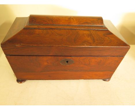 A rosewood sarcophagus tea caddy with ring handles, fitted internally - 32cm x 17cm x 19cm high - in good condition, has a fe