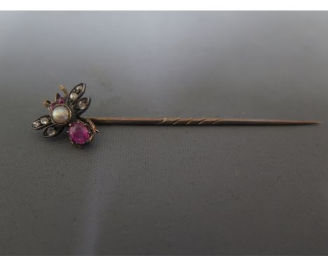 A gold stick pin the top in the form of an insect with diamonds, rubies and a pearl to centreCondition report: Needs cleaning