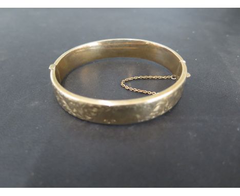 A 9ct yellow gold bangle - 6.5cm x 5.8cm - approx weight 13.8 grams - some usage, generally good