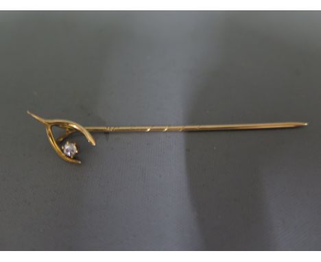 A 15ct gold stick pin with wishbone top and diamondCondition report: In good order