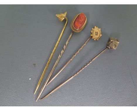 Four stick pins, one with diamond to top, one with engraved cube to top, one with foxes head to top and one with cameo to top