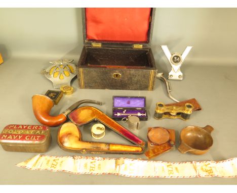 A box containing miscellaneous items including pipes, eye glasses, opera glasses, treen bowl, Victoria 60 year anniversary sa