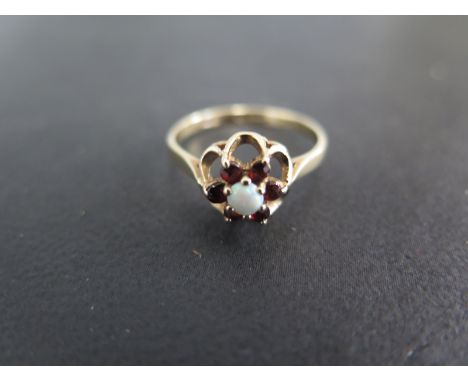 A 9ct yellow gold opal and garnet dress ring  - Weight approx. 1.9gms  - Ring size N