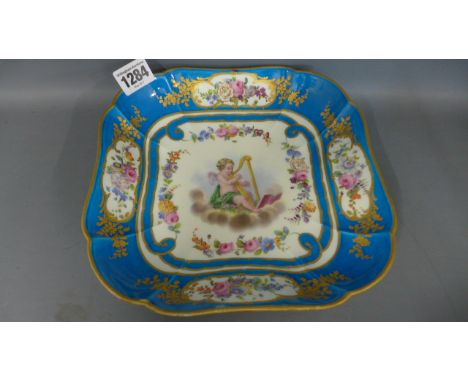 A Sevres square dish painted with a harp playing cherub within a bleu celeste border, crossed LL marks, dated 1798, painted b