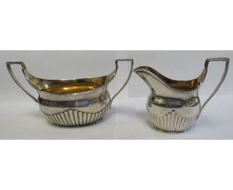 A silver cream jug, London, West &amp; Son,1894, half gadrooned, 106.92g gross; and a silver two handled sucrier, London, Edw