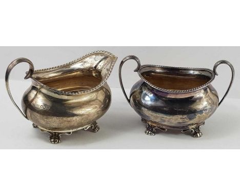 A matching silver milk jug and two handled sucrier, Sheffield, Atkin Brothers, 1904; each on four feet and with twisted rope 