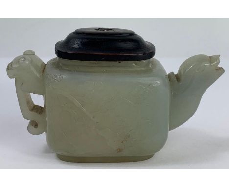 An 18th century Chinese model of a teapot, carved with bamboo, flowers and other plants, 3.8c high, 7.8cm long 