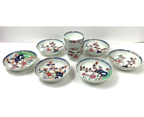 A collection of seven 19th century tea bowls, each decorated with various flowers and plants, along with six similar saucers 