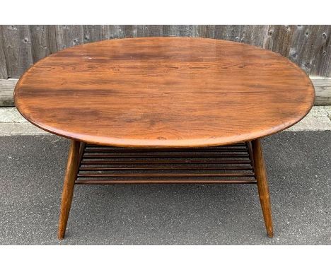 An Ercol beech and elm oval coffee table, with magazine shelf, 44cm high, 103cm long, 80cm wide 