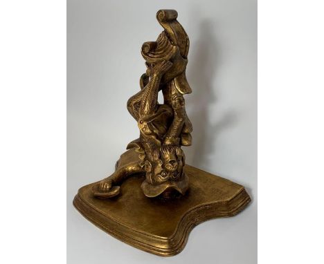 A 20th century gilded wall bracket/shelf, the shelf supported by a monkey figure, 38cm high, 35cm long 