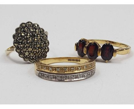 A 9ct yellow and white gold diamond two row band ring, finger size R, a 9ct gold three stone garnet ring, finger size P, 7.38