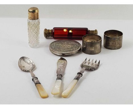 A pair of silver napkin rings with engine turned decoration, 2.821 tory oz gross; a silver topped scent bottle, with hob nail