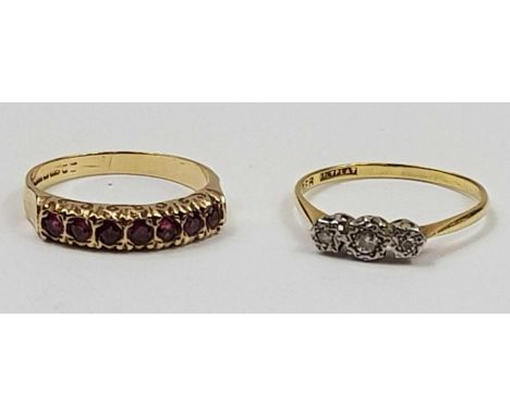 A 9ct gold ruby half eternity ring, finger size R, 2.73g gross, and a three stone diamond ring, the three diamonds illusion s