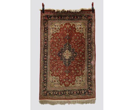 Silk Qum rug, south central Persia, circa 1950s-60s, 5ft. 1in. X 3ft. 2in. 1.55m. X 0.97m. Light red field with ivory and dar