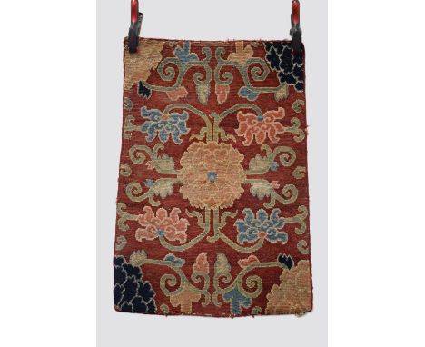 Tibetan chrysanthemum seating rug, inner Asia, early 20th century, 2ft. 8in. X 1ft. 10in. 0.81m. X 0.56m. Some wear in places