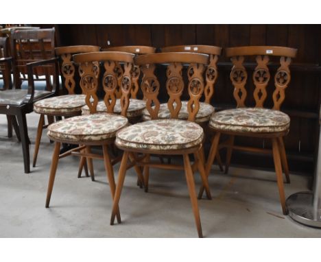 A set of six Ercol dining chairs, fleur de lys style backs, mid/dark colour