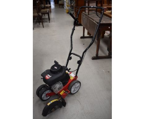 A petrol driven lawn edger , having Briggs and Stratton engine, model MTD 550G