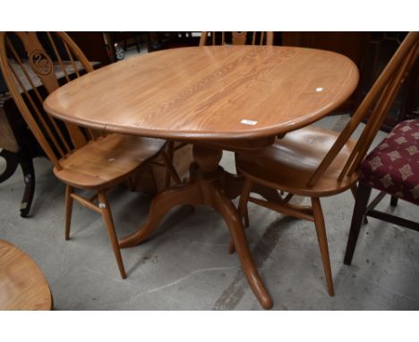 A modern light elm Ercol extending dining table