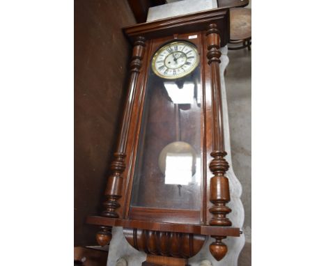 An early 20th century mahogany Vienna wall clock having ceramic dial with Roman numerals, with red motif between, signed with