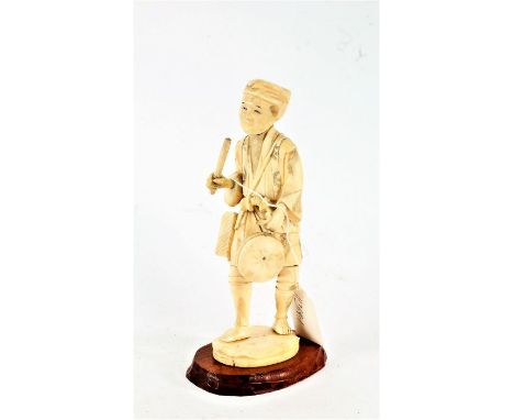 Japanese Meji period okimono, depicting a smiling man holding a drum and stick, signed to the base, 18cm high, on a later sta