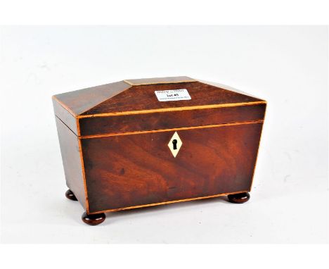 Regency mahogany sarcophagus shaped tea caddy, with boxwood inlay, the hinged lid enclosing a two compartment interior, raise