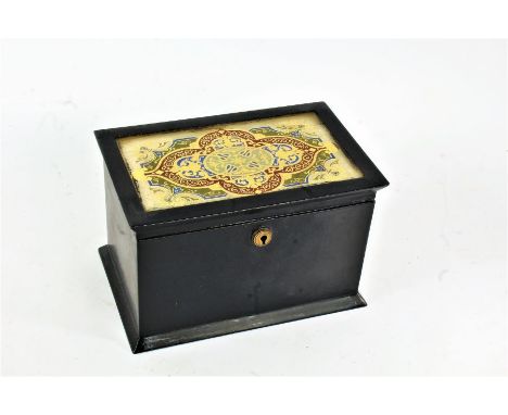 Unusual 19th century toleware tea caddy, the hinged lid with a glass topped gilded motif with bright colours, enclosing a two