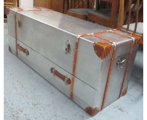 AVIATOR STYLE LOW TRUNK, tan leather bound with a rectangular rising top enclosing space for storage, a carrying handle to ea